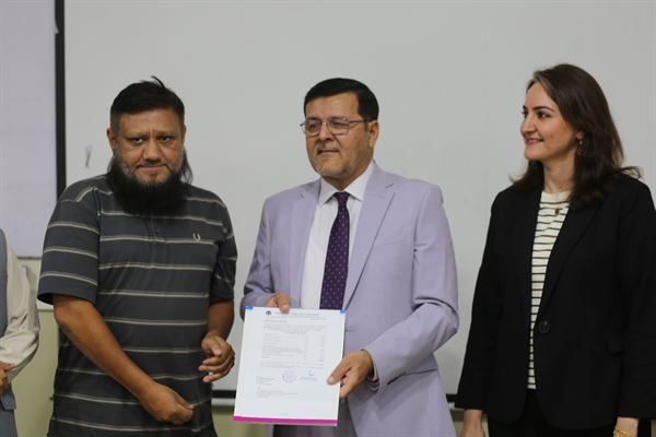 A member of the support staff receiving his promotion letter