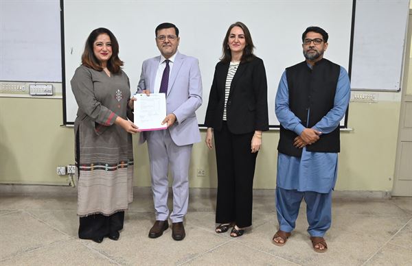 A colleague receiving her promotion letter from the Director, with senior officials of the Campus present