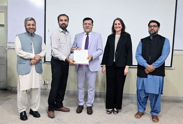A colleague receiving one of more than eighty promotion letters presented at the ceremony